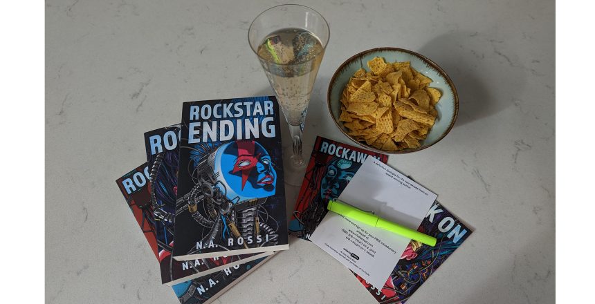 Rockstar Ending books, champagne, chips, pen