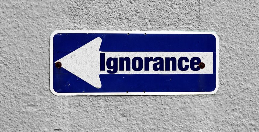 road sign saying ignorance